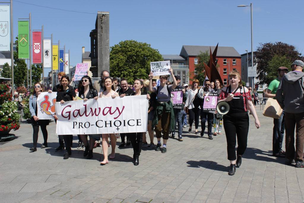 A group of Galway Pro-Choice protesters walking in Eyre Square Galway holding up a sign which says Galway Pro-Choice