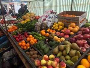 An image of a variety of fruits displayed on a farmer’s market stand