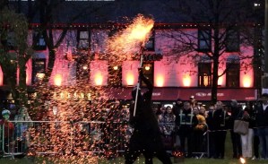 fire show with a man throwing ashes in Eye square