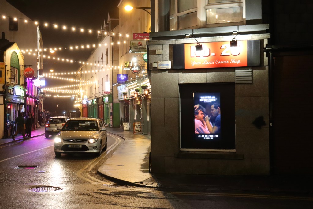 A promotion for All of Us Strangers displayed across the street from Bar Nova in Galway.