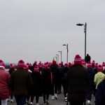 People walking with pink bobble hat on Nimmos Pier in Galway